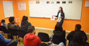 image of a woman teaching a class at New Door Ventures #feedbackempowers