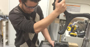 image of Anderson in a robotics class at Pivotal STEM and career-services program
