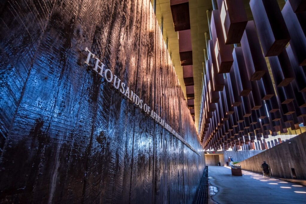 Water wall inscription at National Memorial for Peace and Justice memorializing more than 4,400 Black victims of racial terror lynchings between 1877 and 1950. Their names are engraved on more than 800 steel monuments—one for each county where a racial terror lynching took place